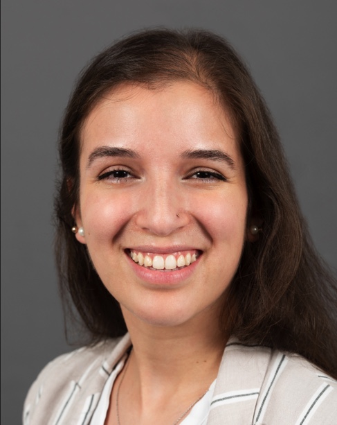 Headshot of Sarah Dickerson, a woman with dark brown hair.