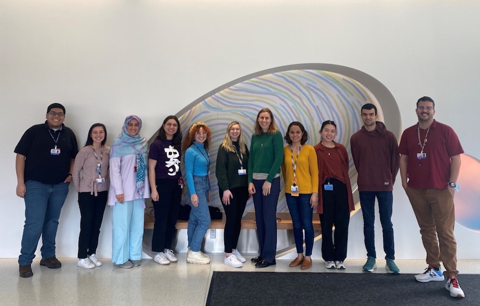 Group of men and women lab members of the faja lab standing in a line