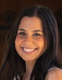 Headshot of Sophie Hurewitz, a woman with long curled brown hair smiles at the camera.