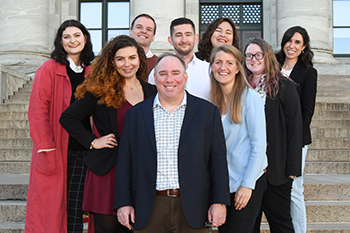 Joseph Italiano and lab members standing outside building