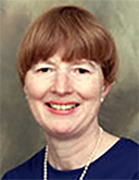 Headshot of Jean Emans, a woman with short cropped brown hair.