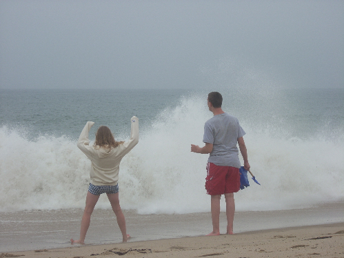 Child and parent walking on beach